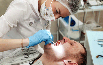 Dental hygienist working on dental exam - Washington Periodontics - Dr. Christine Karapetian