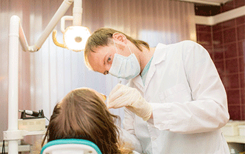 Dental hygienist working on dental dental cleaning - Washington Periodontics - Dr. Christine Karapetian