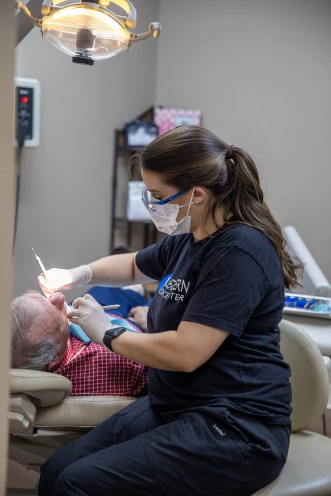 Dental hygienist working on patient - Washington Periodontics - Dr. Christine Karapetian